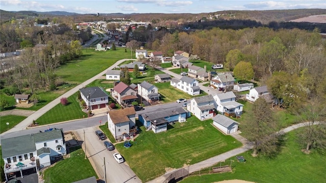 drone / aerial view with a residential view and a view of trees