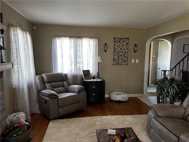 408 Craigdell Rd, New Kensington, PA 15068 - living area with arched walkways, stairs, a wealth of natural light, and wood finished floors