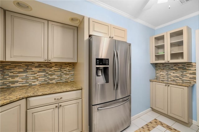 kitchen featuring stainless steel fridge, baseboards, crown molding, and cream cabinets