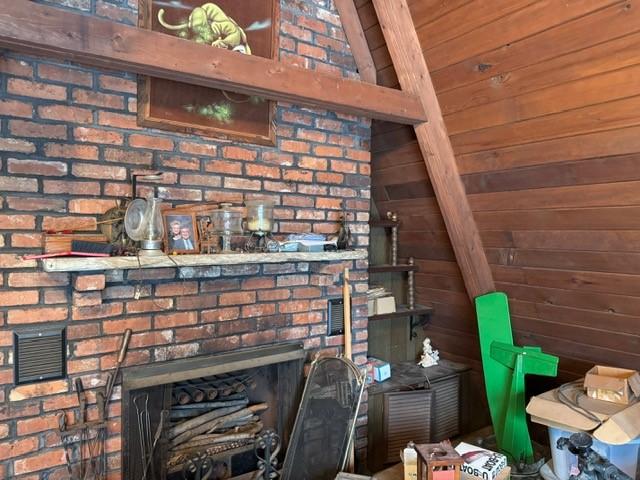 details with wood walls and a brick fireplace
