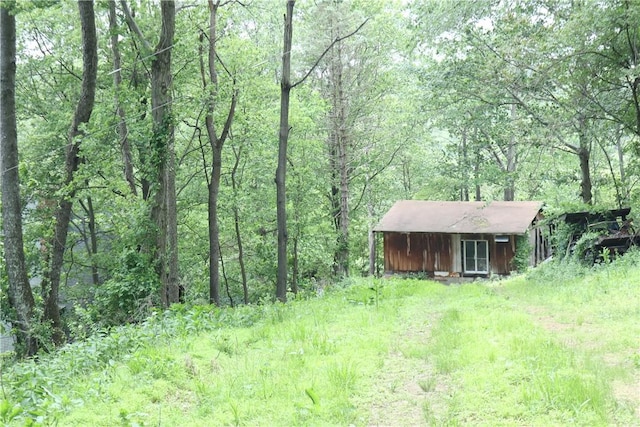 27 S California Dr, W Pike Run Twp, PA 15427 - view of yard with a forest view, an outbuilding, and a storage unit