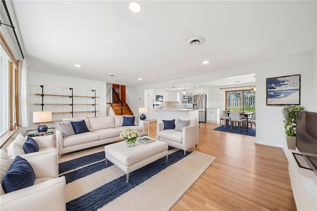 3352 Evergreen Dr, Murrysville, PA 15668 - living room with visible vents, light wood-type flooring, recessed lighting, and stairs