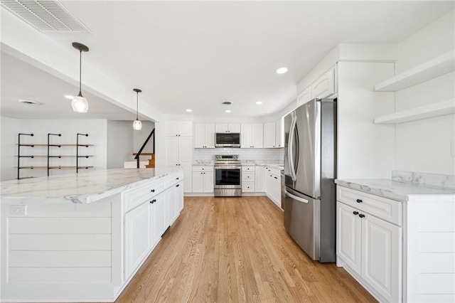 3352 Evergreen Dr, Murrysville, PA 15668 - kitchen featuring stainless steel appliances, open shelves, a large island, light wood-type flooring, and visible vents