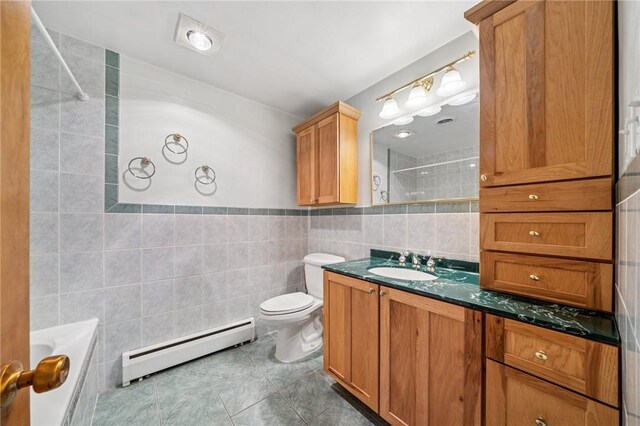 3352 Evergreen Dr, Murrysville, PA 15668 - bathroom with tile walls, a bathing tub, toilet, tile patterned flooring, and baseboard heating