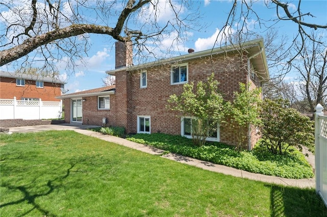 3352 Evergreen Dr, Murrysville, PA 15668 - back of property featuring a chimney, a yard, brick siding, fence, and a patio