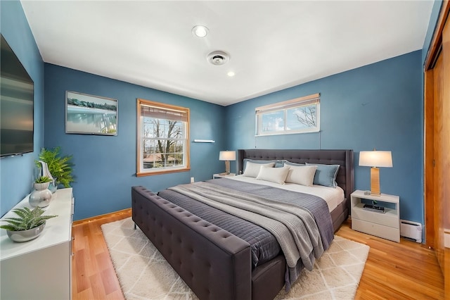 3352 Evergreen Dr, Murrysville, PA 15668 - bedroom with light wood-style floors, recessed lighting, baseboard heating, and multiple windows