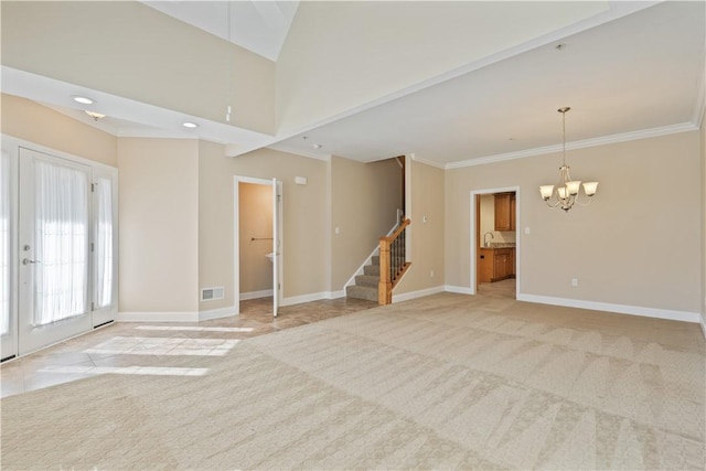 unfurnished living room with an inviting chandelier, stairway, light carpet, baseboards, and visible vents