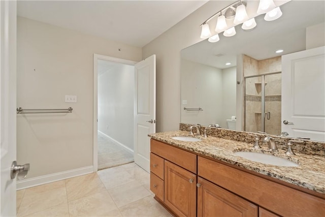 full bathroom featuring baseboards, a stall shower, toilet, and a sink