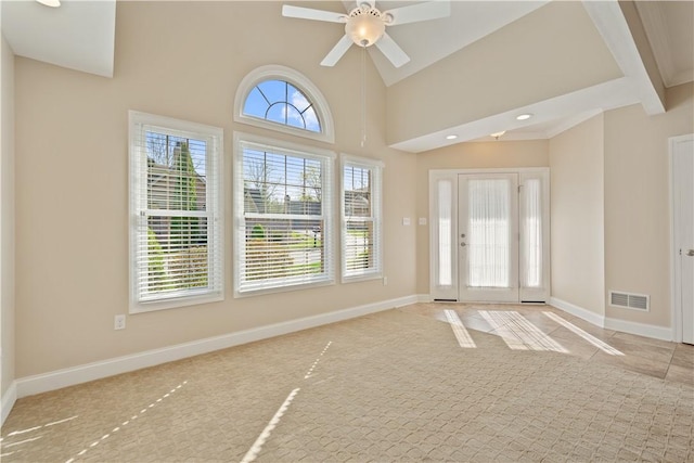 foyer entrance with visible vents, ceiling fan, baseboards, recessed lighting, and high vaulted ceiling