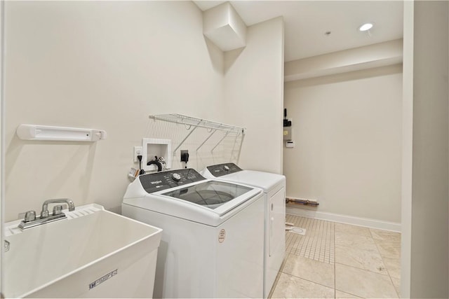 laundry area featuring recessed lighting, a sink, washing machine and clothes dryer, and laundry area