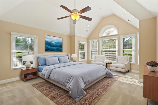 bedroom with light colored carpet, a ceiling fan, high vaulted ceiling, and baseboards