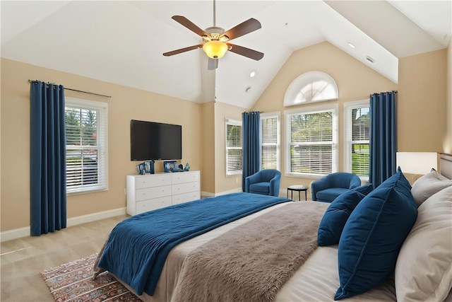 bedroom with a ceiling fan, vaulted ceiling, light carpet, and baseboards