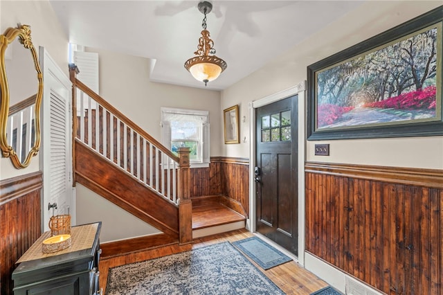 408 N Wade Ave E, Washington Boro, PA 15301 - foyer entrance with stairs, wainscoting, wood walls, and wood finished floors