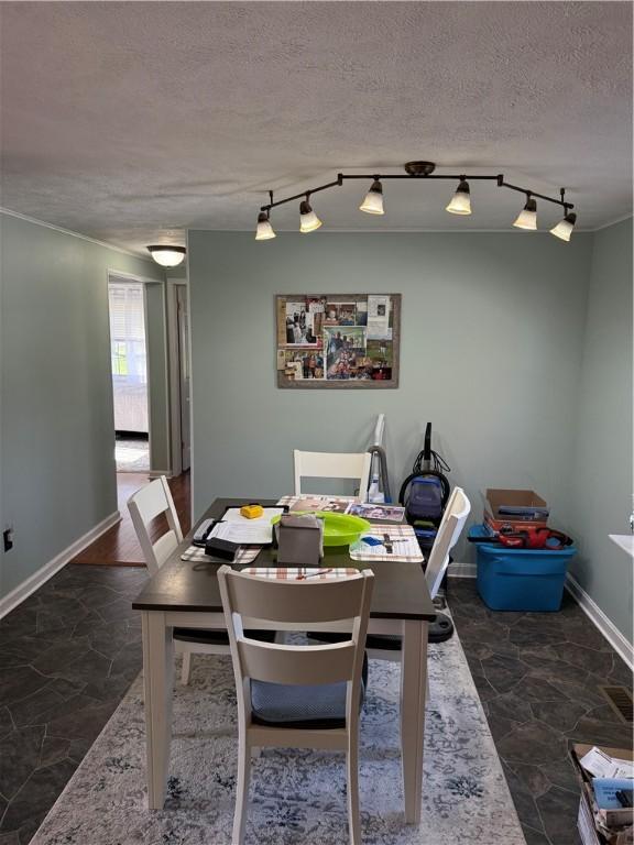 1611 Oneida Valley Rd, Concord Twp, PA 16025 - dining room with baseboards, rail lighting, and a textured ceiling