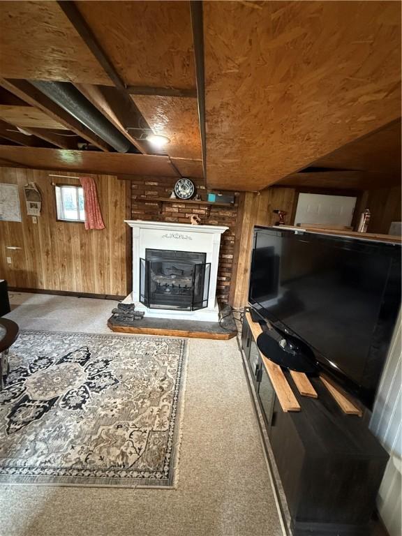 1611 Oneida Valley Rd, Concord Twp, PA 16025 - carpeted living room with a glass covered fireplace and wooden walls