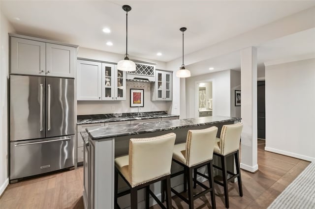 331 Boundary St, Sewickley, PA 15143 - kitchen featuring a breakfast bar, a center island, wood finished floors, and high quality fridge