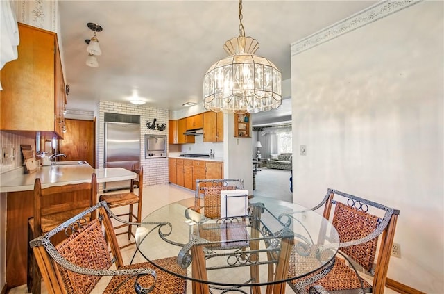 dining space featuring baseboards and a notable chandelier