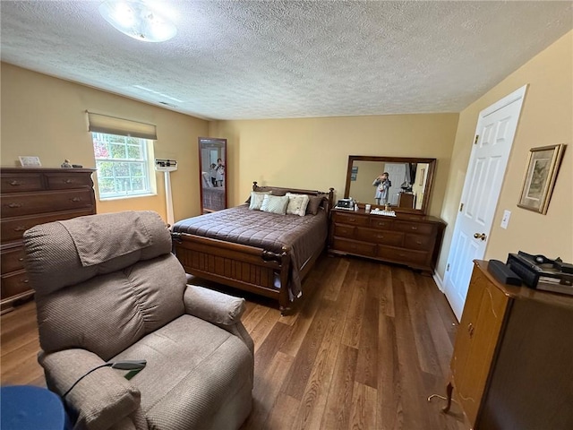 bedroom featuring a textured ceiling and wood finished floors