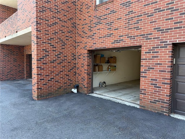 exterior space with brick siding and a garage