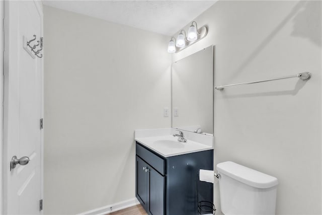 bathroom featuring toilet and vanity
