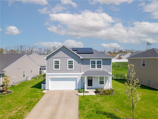 traditional home featuring driveway, fence, board and batten siding, and an attached garage