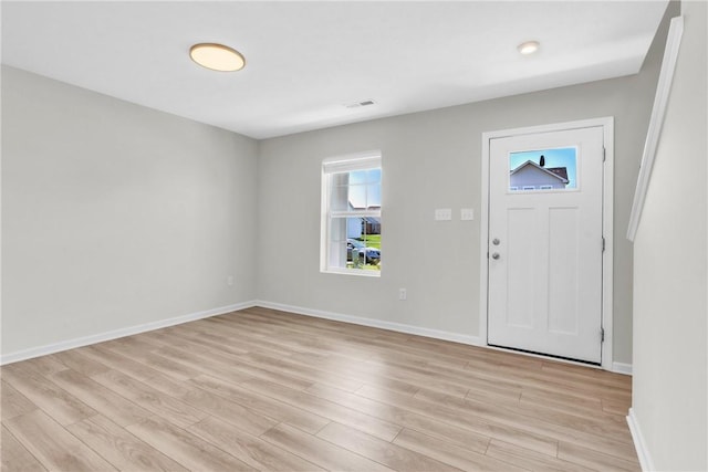 foyer with visible vents, light wood-style flooring, and baseboards