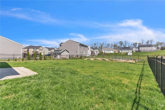 view of yard with fence and a residential view