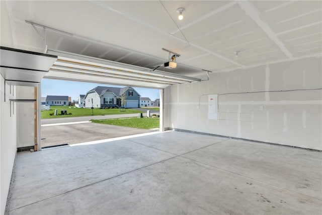 garage with a garage door opener and a residential view