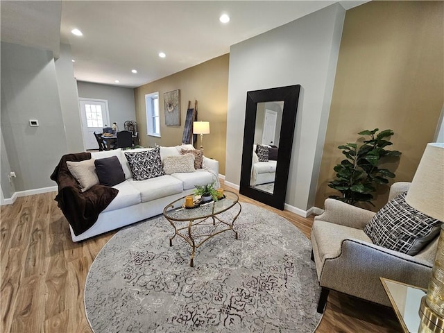 living area featuring recessed lighting, baseboards, and wood finished floors
