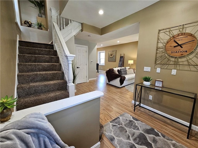 interior space with baseboards, recessed lighting, and wood finished floors