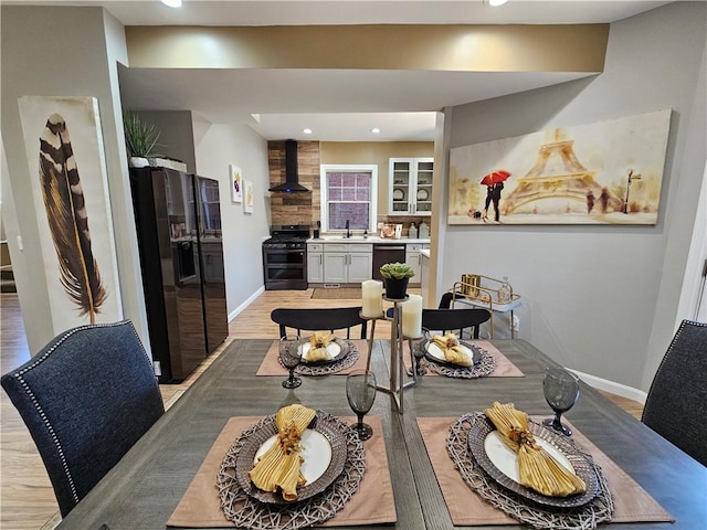 dining space featuring recessed lighting, baseboards, and light wood-style floors