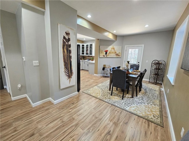 dining room featuring recessed lighting, baseboards, and light wood finished floors