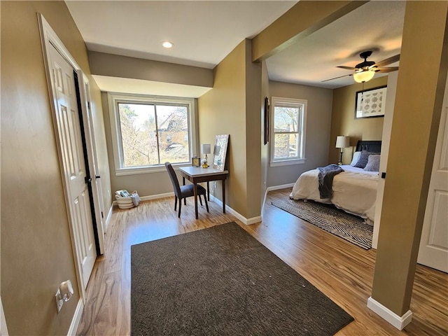 bedroom with baseboards and wood finished floors