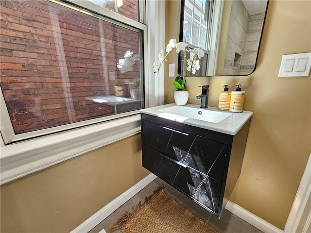 bathroom featuring baseboards and vanity