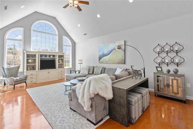 living room featuring recessed lighting, a ceiling fan, visible vents, and wood finished floors