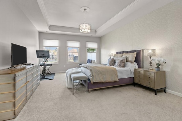 bedroom with a tray ceiling, carpet floors, and baseboards