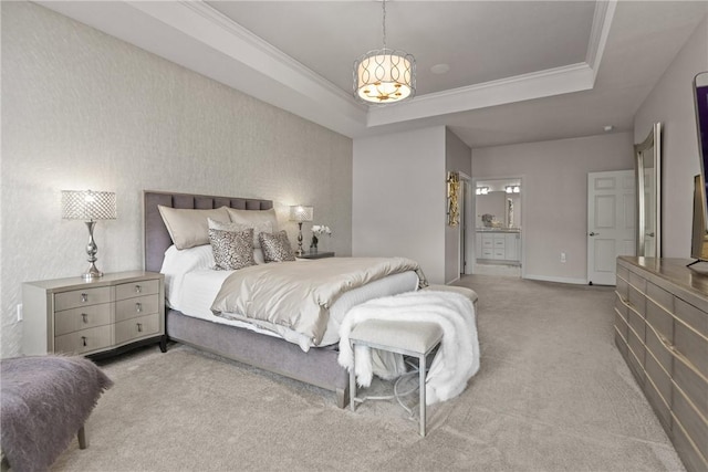 bedroom with connected bathroom, light colored carpet, a tray ceiling, baseboards, and ornamental molding