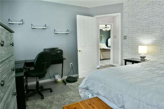 bedroom featuring a chandelier, carpet, and baseboards