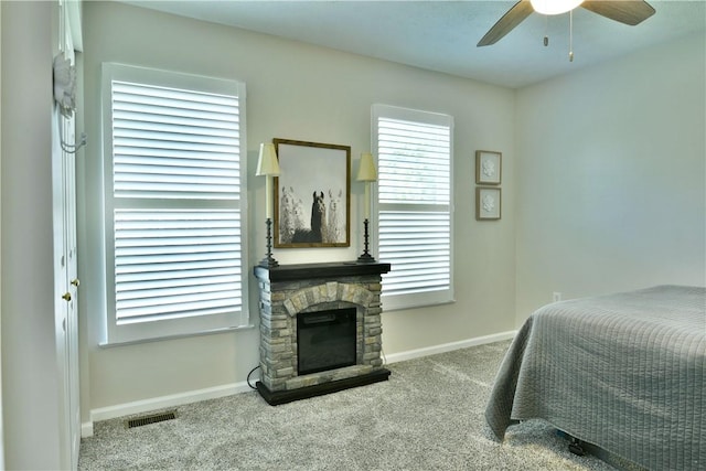 bedroom with a fireplace, visible vents, carpet, and baseboards