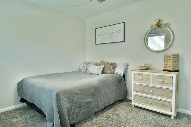 bedroom featuring carpet and baseboards