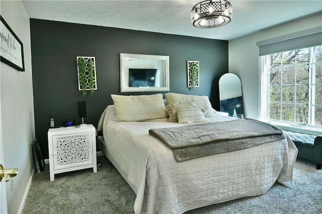 bedroom with carpet flooring and baseboards