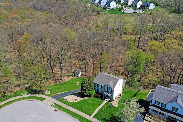 birds eye view of property with a residential view and a wooded view