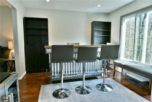 dining area with a wealth of natural light, recessed lighting, and dark wood-type flooring