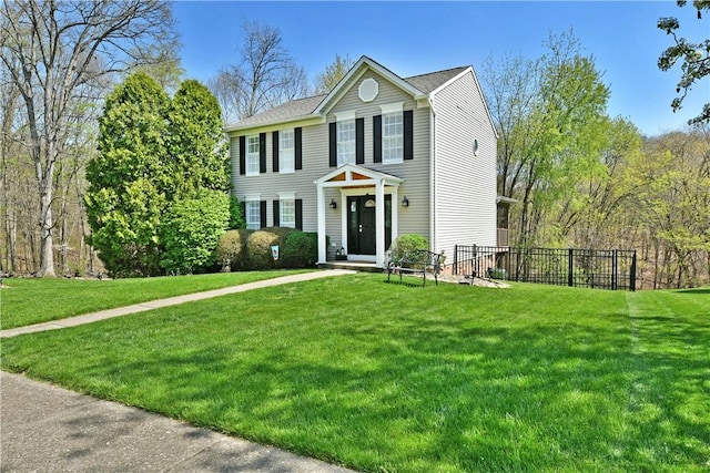 view of front of house with fence and a front lawn