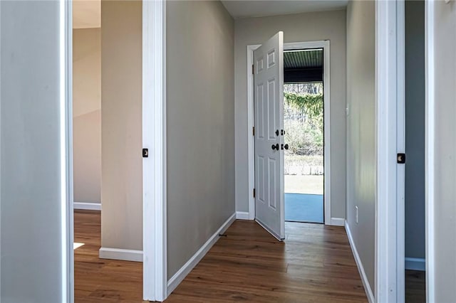 entryway with wood finished floors and baseboards