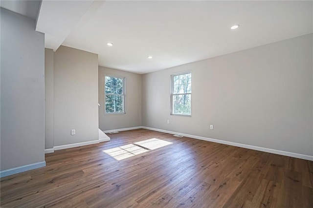 spare room with recessed lighting, wood finished floors, and baseboards