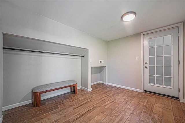 interior space featuring wood finished floors and baseboards