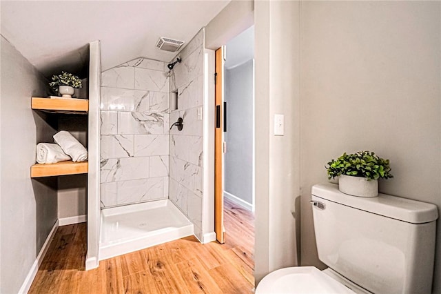 full bath with visible vents, a shower stall, wood finished floors, and baseboards