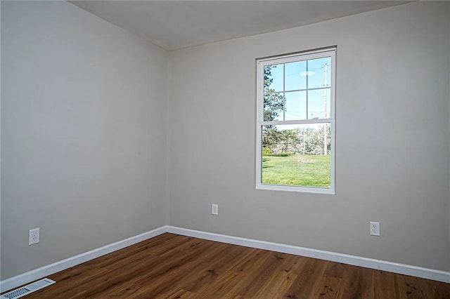 spare room featuring visible vents, plenty of natural light, and baseboards