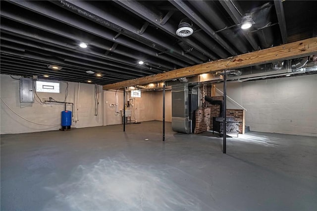 below grade area featuring heating unit and electric panel
